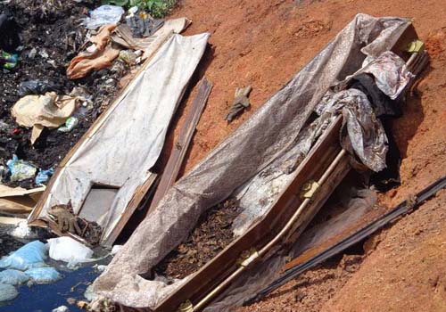 Coveiro 'limpa' sepultura e despeja restos de caixão na porta de cemitério
